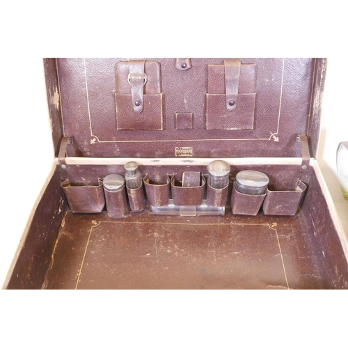 39 - A Finnigans pigskin suitcase with hallmarked silver topped vanity bottles, 23