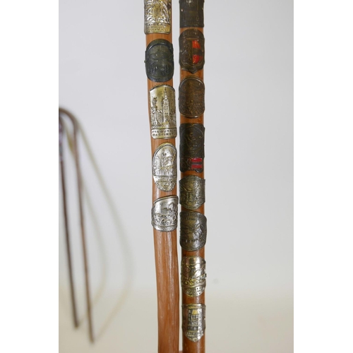 57 - Three hiking canes with associated badges applied to the shafts, together with a hallmarked silver m... 