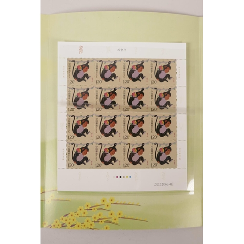 59 - A facsimile (replica) Chinese stamp collection commemorating the year of the monkey, together with a... 