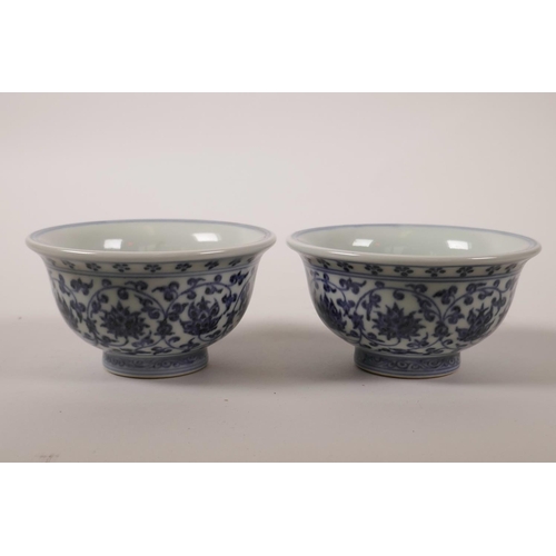 63 - A pair of Chinese blue and white porcelain tea bowls with scrolling lotus flower decoration, 4 chara... 