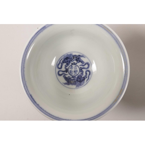 63 - A pair of Chinese blue and white porcelain tea bowls with scrolling lotus flower decoration, 4 chara... 