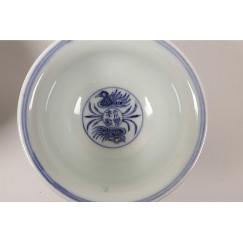 63 - A pair of Chinese blue and white porcelain tea bowls with scrolling lotus flower decoration, 4 chara... 