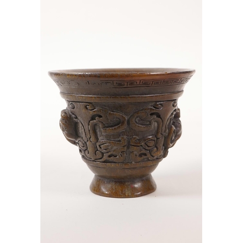 65 - A Chinese faux horn libation cup with carved kylin decoration, 4 character mark to base, 3