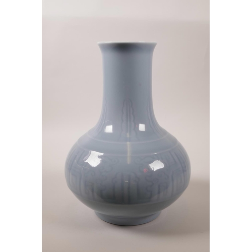 70 - A Chinese powder blue glazed porcelain vase with archaic style underglazed decoration, 11