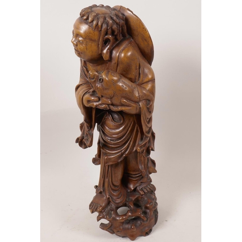 21 - A Chinese carved rootwood figurine of a sage holding a three legged toad (Chan Chu), A/F