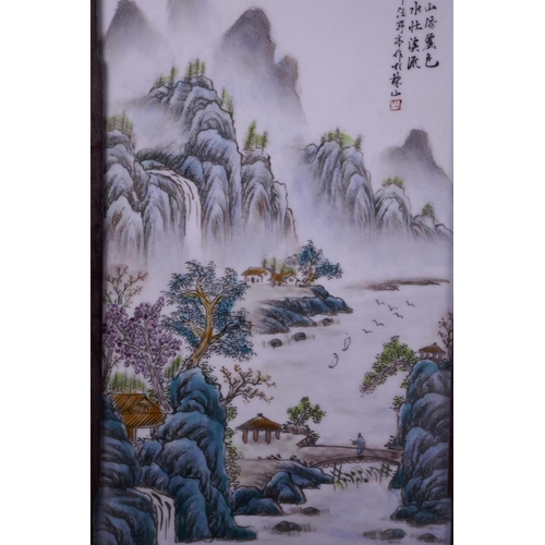 23 - A pair of Chinese famille verte porcelain panels depicting river and mountain scenes, mounted in har... 