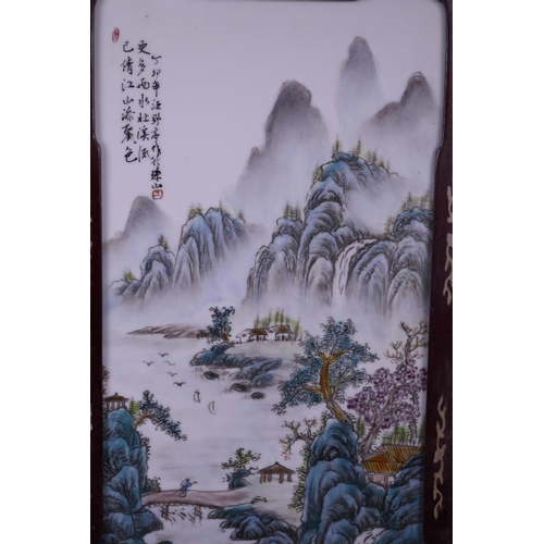 23 - A pair of Chinese famille verte porcelain panels depicting river and mountain scenes, mounted in har... 