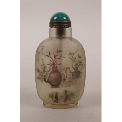 30 - A Chinese reverse painted glass snuff bottle depicting a riverside landscape and vases of flowers, 3... 