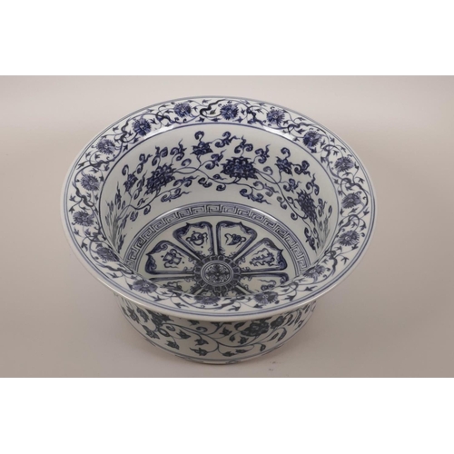 35 - A large Chinese blue and white porcelain steep sided bowl decorated with lotus flowers and the emble... 