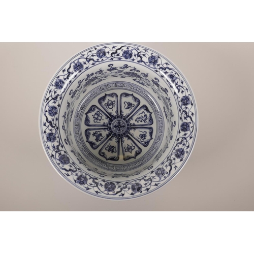 35 - A large Chinese blue and white porcelain steep sided bowl decorated with lotus flowers and the emble... 