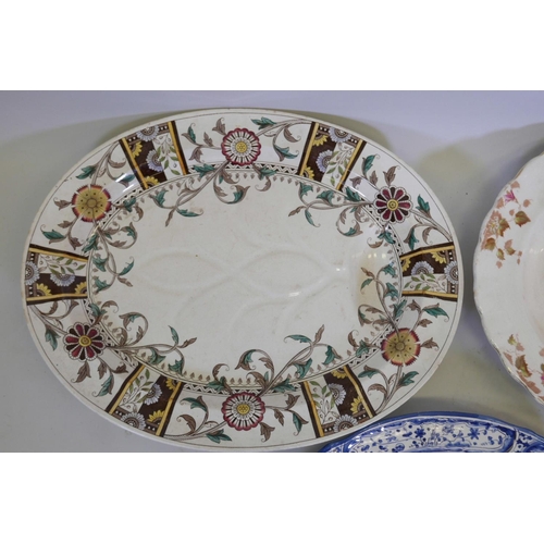 42 - A large C19th ironstone meat platter with drainage channels and well decorated with a scrolling flor... 