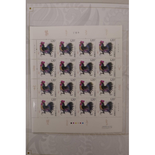 47 - A wallet of facsimile (replica) Chinese stamps commemorating the 2017 Year of the Rooster, 8½