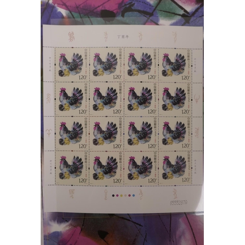 47 - A wallet of facsimile (replica) Chinese stamps commemorating the 2017 Year of the Rooster, 8½