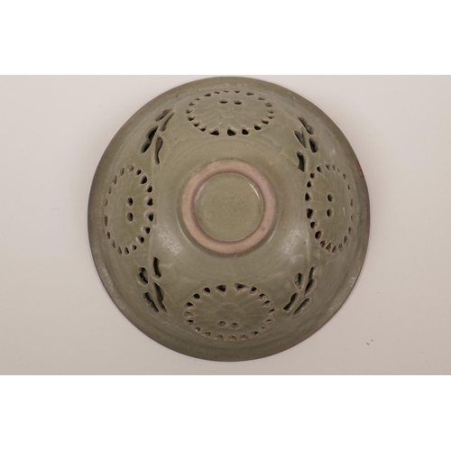 51 - A Chinese olive glazed Song style bowl with incised and reticulated floral decoration, 7