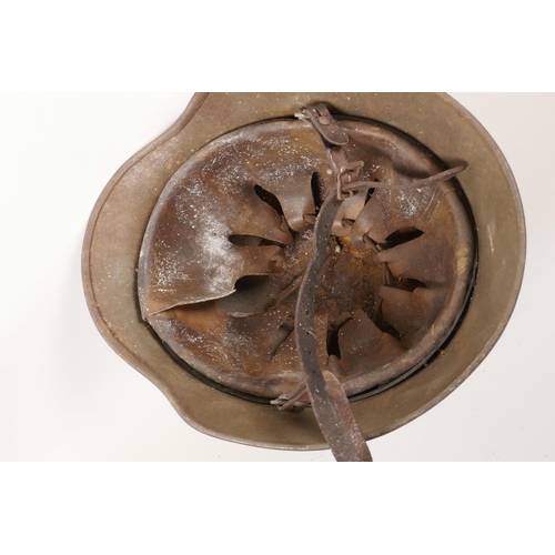 6 - A WWII German steel combat helmet with leather interior, and eagle and swastika decal to side