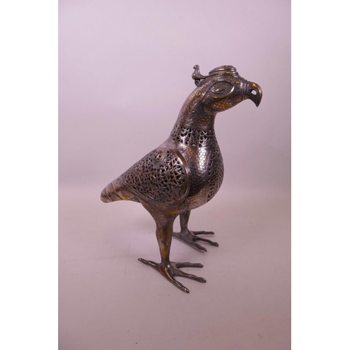 49 - An Islamic silvered metal censer in the form of a bird with pierced scrolling decoration, 12