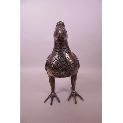 49 - An Islamic silvered metal censer in the form of a bird with pierced scrolling decoration, 12