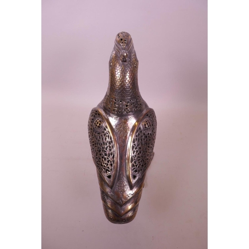 49 - An Islamic silvered metal censer in the form of a bird with pierced scrolling decoration, 12