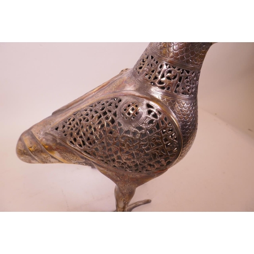 49 - An Islamic silvered metal censer in the form of a bird with pierced scrolling decoration, 12