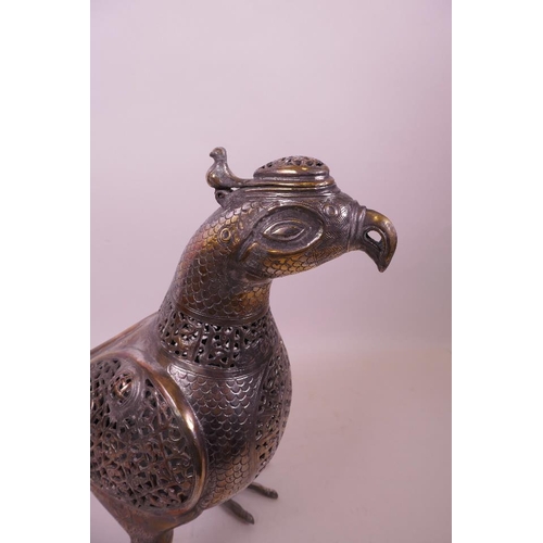 49 - An Islamic silvered metal censer in the form of a bird with pierced scrolling decoration, 12