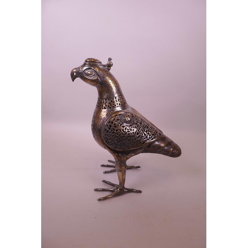 49 - An Islamic silvered metal censer in the form of a bird with pierced scrolling decoration, 12