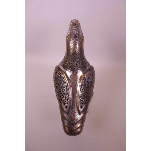 49 - An Islamic silvered metal censer in the form of a bird with pierced scrolling decoration, 12