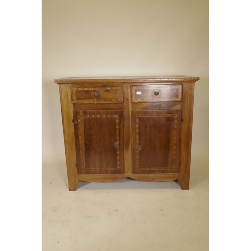 1132 - A late C18th French inlaid walnut buffet, with two drawers over two cupboards, raised on shaped supp... 