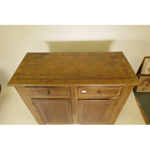 1132 - A late C18th French inlaid walnut buffet, with two drawers over two cupboards, raised on shaped supp... 