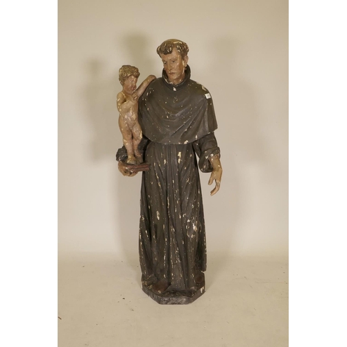 1133 - A C19th carved and painted pine figure of St Joseph with the Christ Child, 52