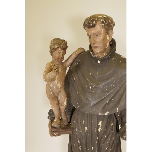 1133 - A C19th carved and painted pine figure of St Joseph with the Christ Child, 52