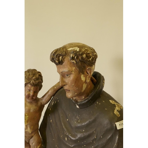 1133 - A C19th carved and painted pine figure of St Joseph with the Christ Child, 52