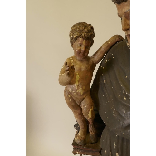 1133 - A C19th carved and painted pine figure of St Joseph with the Christ Child, 52