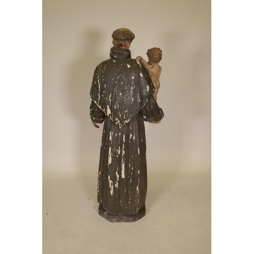 1133 - A C19th carved and painted pine figure of St Joseph with the Christ Child, 52