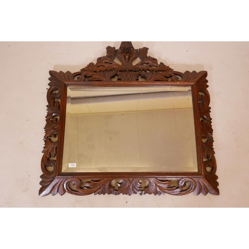 1134 - A C19th French carved oak cushion wall mirror, with original bevelled glass plate and carved lion cr... 