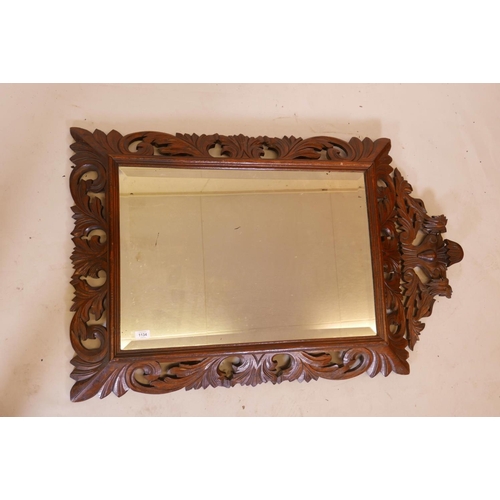 1134 - A C19th French carved oak cushion wall mirror, with original bevelled glass plate and carved lion cr... 