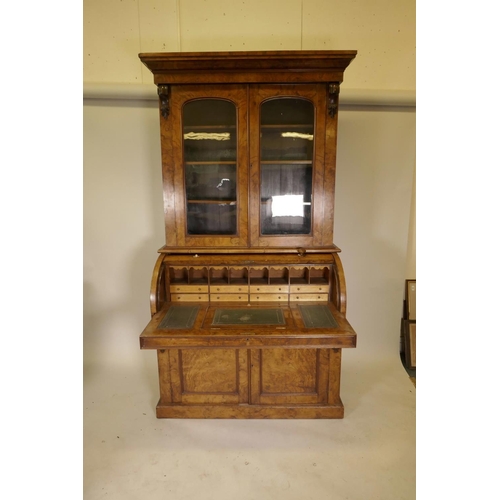 1135 - A Victorian figured and burr walnut cylinder top bureau bookcase, the upper section with arched glaz... 