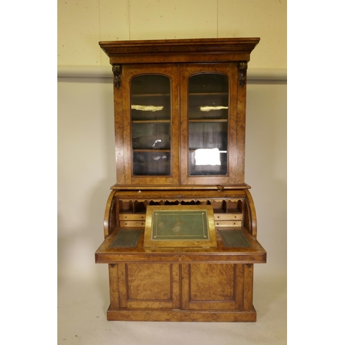 1135 - A Victorian figured and burr walnut cylinder top bureau bookcase, the upper section with arched glaz... 