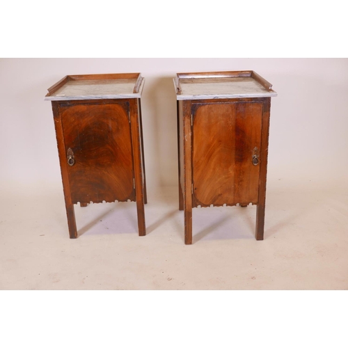 1136 - A pair of Continental mahogany pot cupboards with marble tops and three quarter galleries, 18