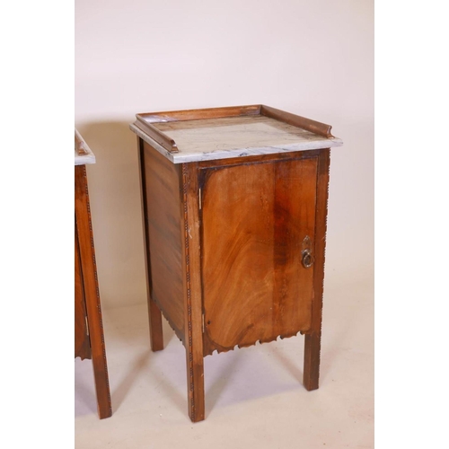 1136 - A pair of Continental mahogany pot cupboards with marble tops and three quarter galleries, 18