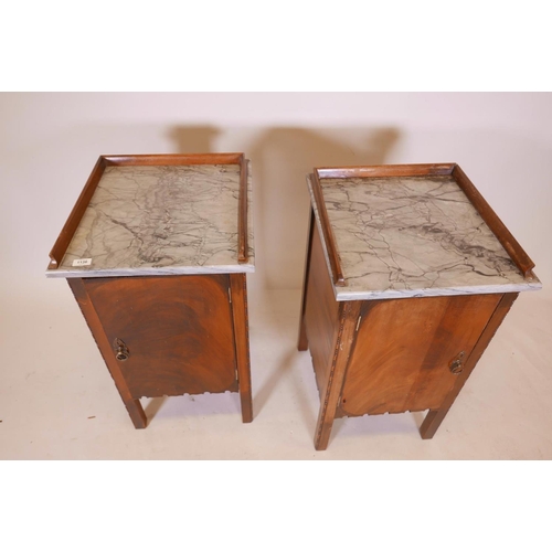 1136 - A pair of Continental mahogany pot cupboards with marble tops and three quarter galleries, 18