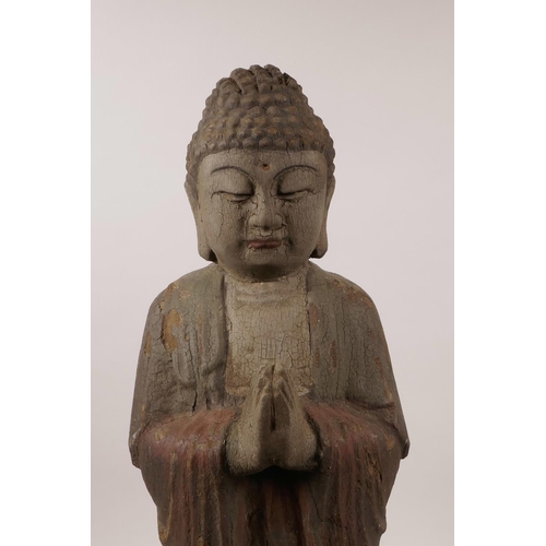 20 - A large Chinese carved and painted wood figure of Buddha standing on a lotus, 22