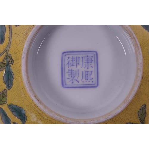 25 - A Chinese yellow ground porcelain rice bowl with polychrome enamelled floral decoration, 4 character... 