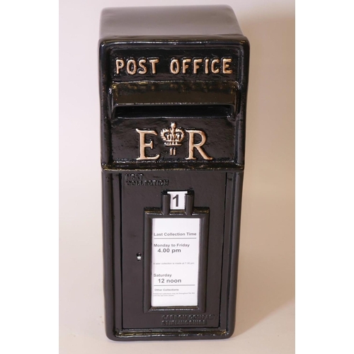 29 - A black metal post box with cast iron front and metal shell, 23