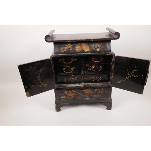 37 - A Japanese Meiji period lacquered table cabinet of pagoda form, the top drawer over two doors reveal... 