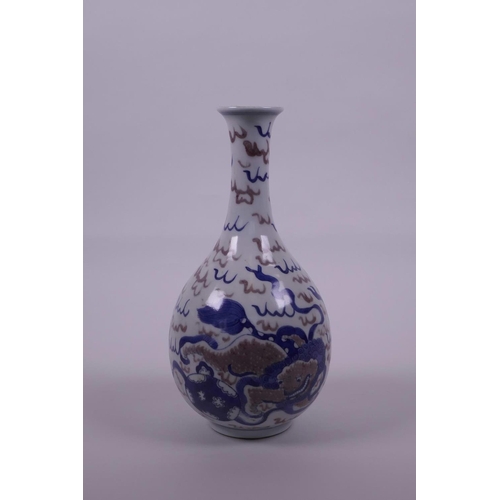 48 - A Chinese blue and white porcelain bottle vase with kylin decoration and red highlights, 9