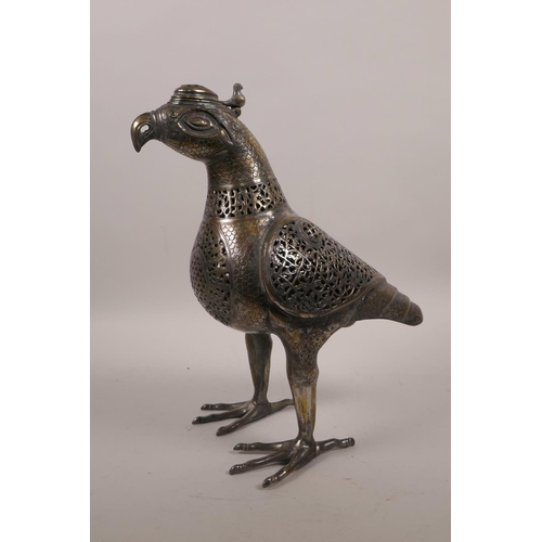 49 - An Islamic silvered metal censer in the form of a bird with pierced scrolling decoration, 12