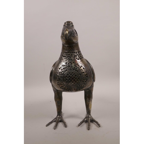 49 - An Islamic silvered metal censer in the form of a bird with pierced scrolling decoration, 12