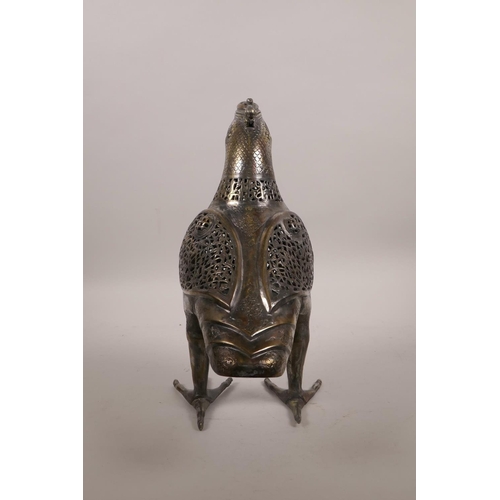 49 - An Islamic silvered metal censer in the form of a bird with pierced scrolling decoration, 12