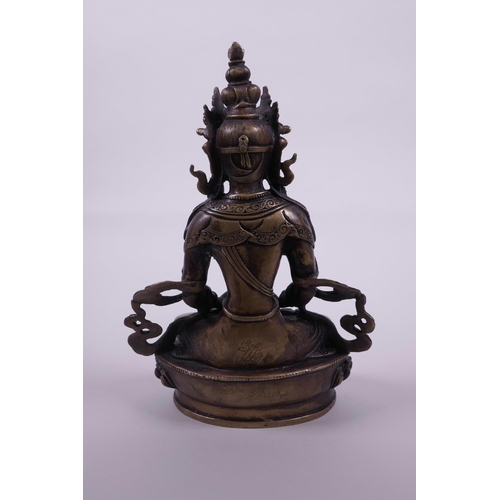 53 - A Sino-Tibetan bronze of Buddha seated on a lotus throne holding a stupa, 8½