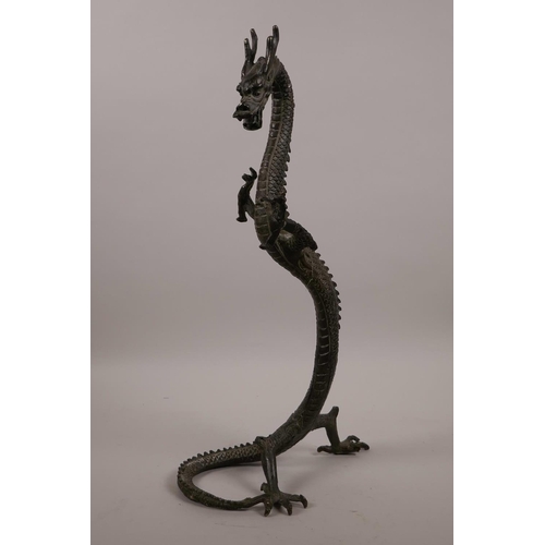 61 - An Oriental bronze figure of a rearing dragon, 16½